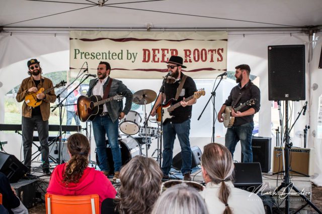 Deep Roots - Pretty Archie - musicians singing in a tent